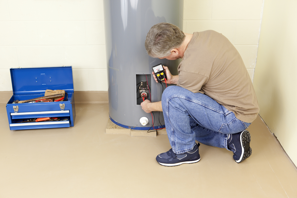 Plumber working on water heater
