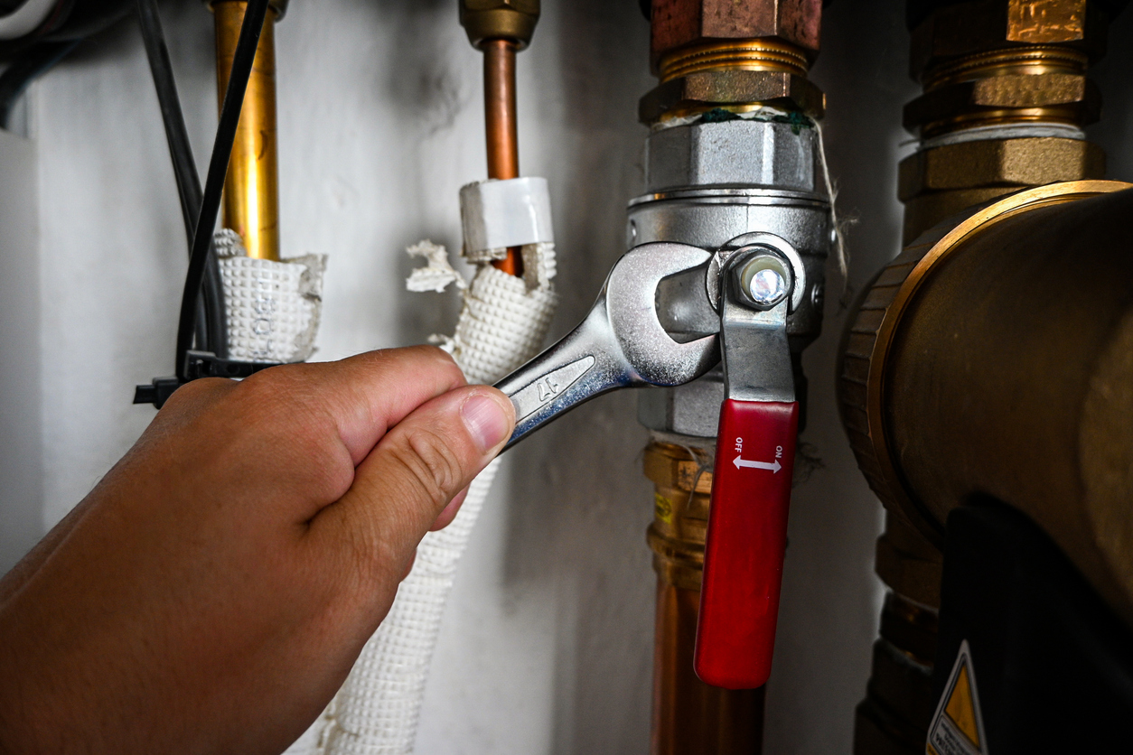 Plumber adjusting nut on water heater