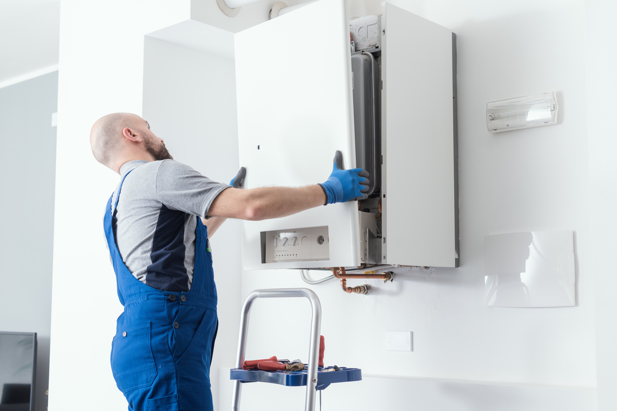 Plumber installing boiler