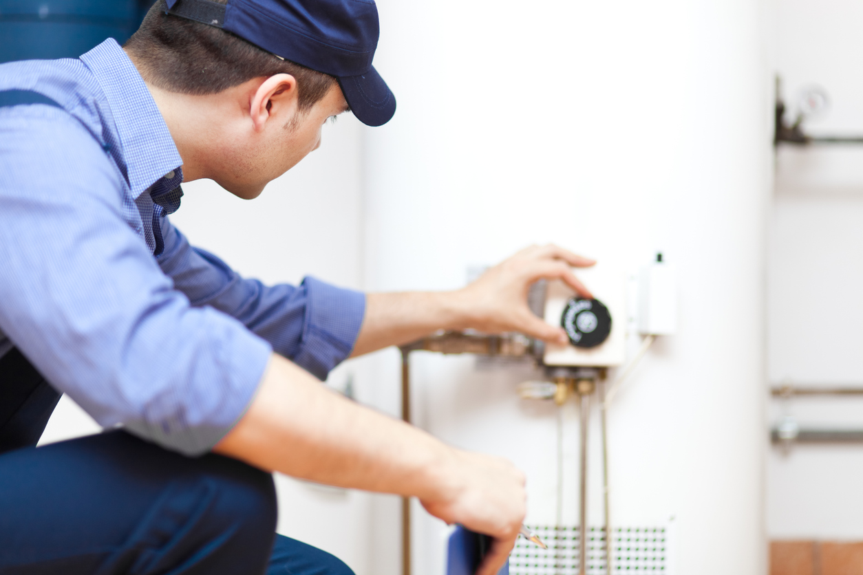 Technician repairing hot water heater