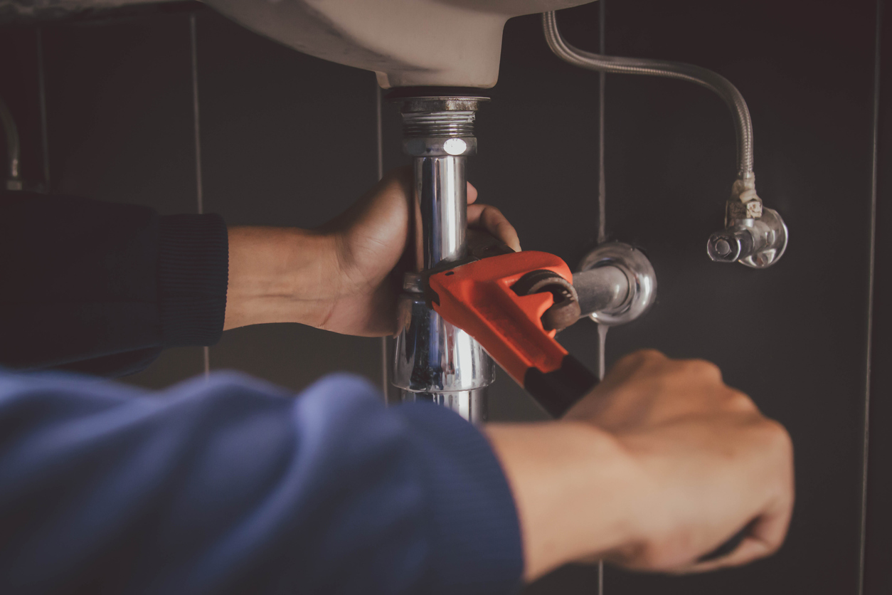 Plumber At Work In A Bathroom